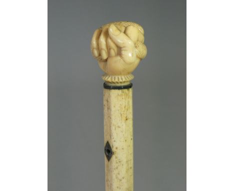 A 19th century whale jaw-bone &amp; ivory-handled walking stick carved with a fist clutching a serpent, the spiral-twist tape