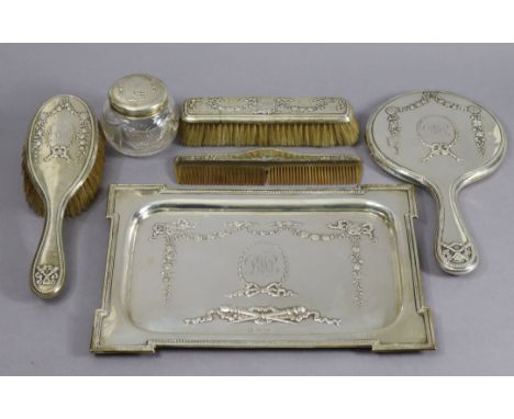 An Edwardian silver five-piece dressing table set comprising a rectangular tray, 11¾” x 8¼”, a hand mirror, a hairbrush, a cl