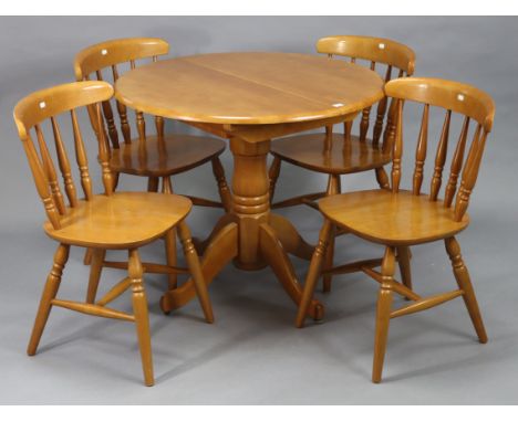 A beech-finish circular extending dining table, with centre leaf &amp; on vase-turned       centre column &amp; four cabriole