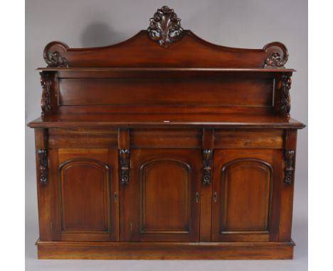 A Victorian-style mahogany sideboard, fitted open shelf to the low-stage panel back, fitted three cushion-fronted frieze draw