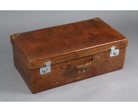 A vintage tan leather suitcase fitted chrome twin-lever locks, 29½” wide x 10½” high x 17” deep.
