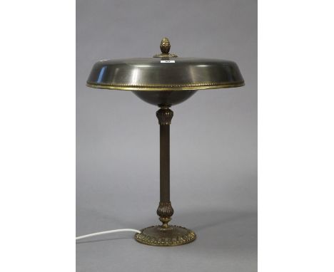 A bronzed table lamp on a fluted centre column &amp; circular base, with shade, 20” high.