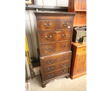 A cross banded chest on chest, the upper section fitted two short over two long drawers, the lower section fitted three long 