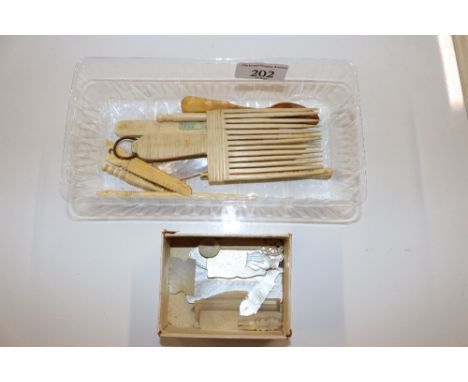 A box containing mother of pearl gaming counters, horn comb etc. 