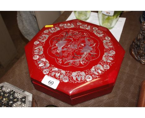 A red lacquer and mother of pearl inlaid box 