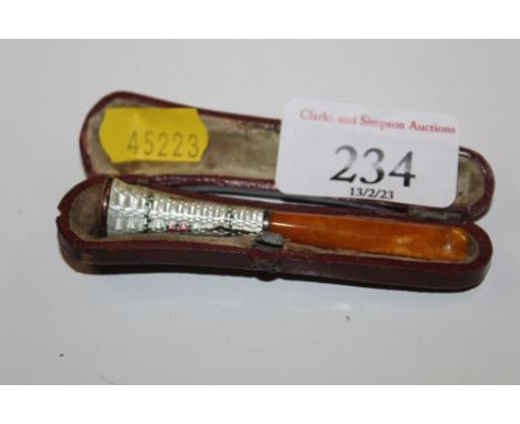 An enamel decorated cheroot holder in case
