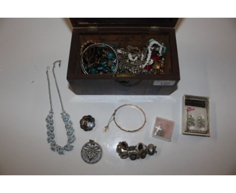 A wooden tea caddy and contents of various costume jewellery including a rolled gold bangle with 9ct gold padlock clasp