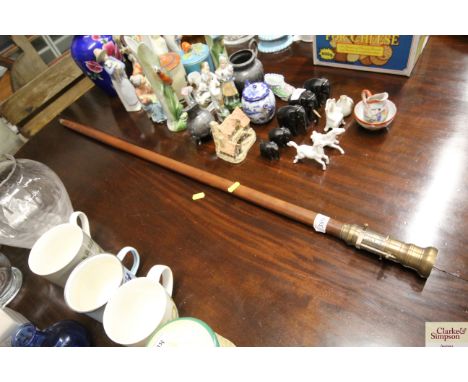 A walking stick with telescope/compass handle