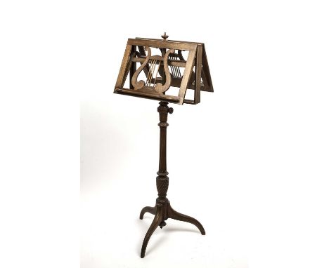 A Regency style height adjustable mahogany duet music stand, the two music rests each adjusting on a ratchet, turned and flut
