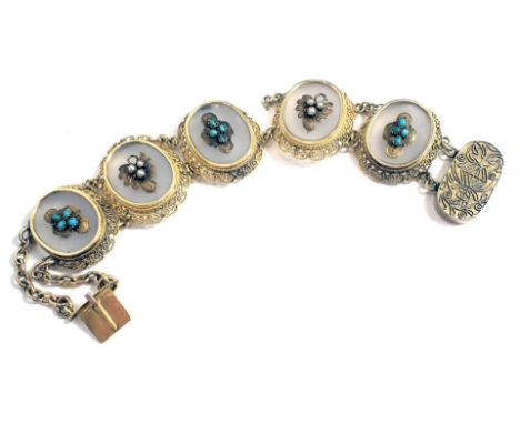 A Chinese filigree five sectional bracelet, each of oval form set with moonstone and raised seed pearl and turquoise, on a fr
