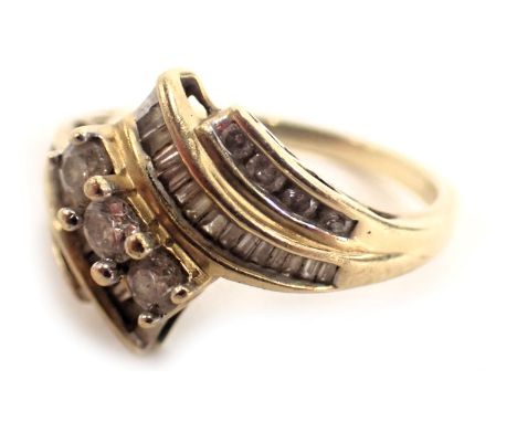 A diamond dress ring, of modern design, with central three round brilliant cut diamonds, each approx 0.08ct, with two splayed
