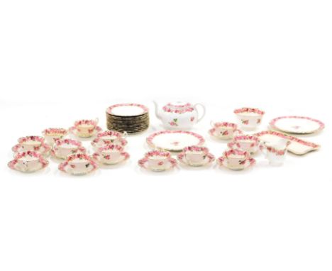 A Royal Doulton pink rose pattern part tea service, comprising teapot, two large plates, a rectangular serving plate, milk ju