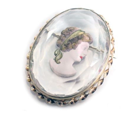 A portrait brooch, of oval crystal design, with painted decoration of a female, in yellow metal border, unmarked, with single