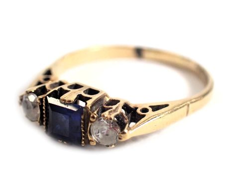 A 9ct gold Art Deco style dress ring, set with central sapphire and flanked by two CZ stones, in a raised basket setting, rin