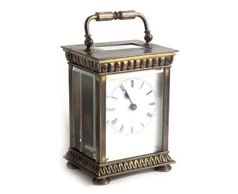 A French brass carriage clock, with enamel dial, the case with columns and cast with leaves, 14cm high. (AF)