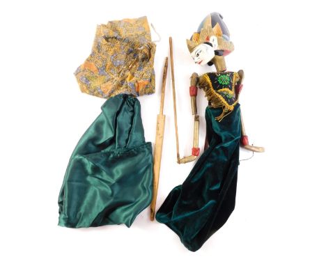 An Eastern dancing puppet, with painted wooden head, the body embellished with sequins, gold coloured braiding, etc., possibl