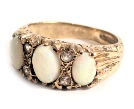 A 9ct gold opal and diamond set gypsy ring, with three oval opals and four tiny diamonds, ring size J½, 3.6g all in. 