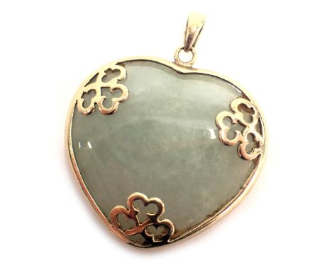 A heart shaped jade locket, in a yellow metal mount stamped 9ct, with partial floral decoration, 2.5cm high, 7.5g all in. 