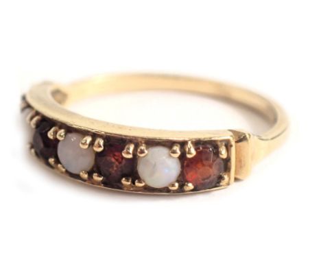 A 9ct gold half hoop dress ring, set with four garnets and three opals, each in claw setting, ring size N½, 2.2g all in. 