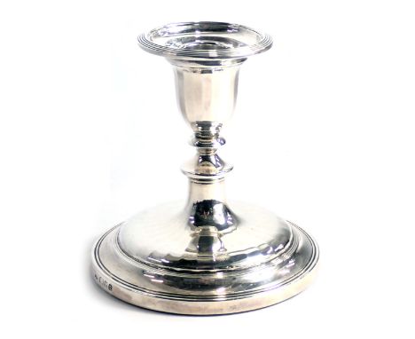 An Elizabeth II silver candlestick, of faceted form, loaded, London 1962, 12cm high. 
