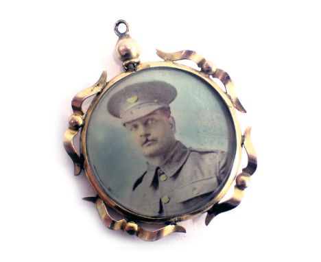 A portrait locket, double sided depicting military figures, yellow metal scroll frame, unmarked, believed to be 9ct gold, 2.5