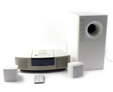 A Bose Wave radio and CD, in white, Bose Acoustimass 3 series IV speaker. 