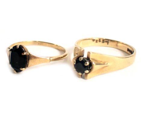 Two dress rings, comprising a 9ct gold sapphire set dress ring of modern design, ring size N½, a garnet single stone set dres