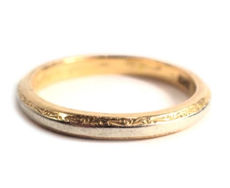 A wedding band, of bicolour design, with central white gold and outer border of yellow gold stamped 750, ring size O, 3.8g. 