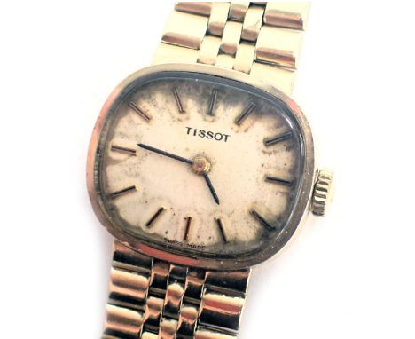 A 9ct gold Tissot wristwatch, with an oblong dial on cream face, with seventeen jewel movement, dial 2cm diameter, the watch 