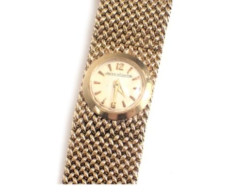 A Jaeger-LeCoultre 9ct gold wristwatch, with a small circular cream coloured watch head, 1cm diameter, on cross weave design 