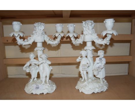 PAIR OF BLANC DE CHINE CANDELABRA DECORATED WITH FIGURAL BASES AND FLORAL DETAIL, 27CM HIGH