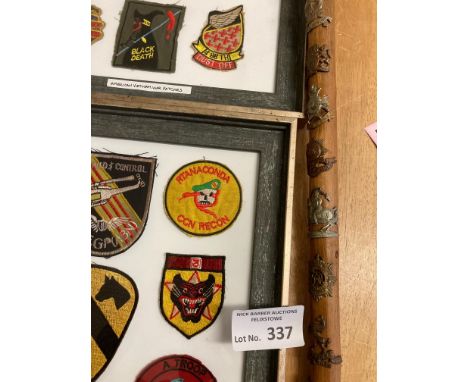 Militaria : 2 frames of American Vietnam War Patches plus walking stick emblazened with badges from various groups/countries