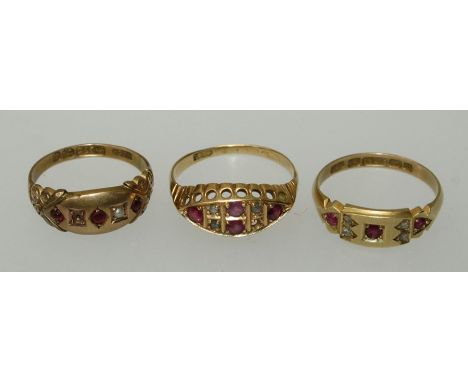 A 15 carat gold three stone ruby ring, set with four diamond chips, size O and two 9 carat ruby set rings, each with deficien