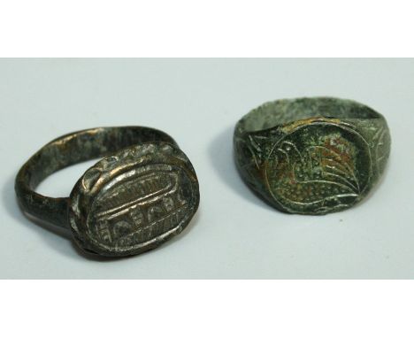 A Roman  style bronze Ring with oval plate bezel having crescent and striped markings together with another bronze Ring, with