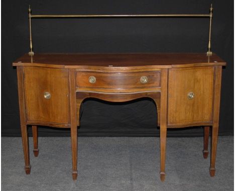 A Victorian mahogany, chequer sideboard, the brass rail over serpentine top and frieze drawer, flanked by cupboards with bras