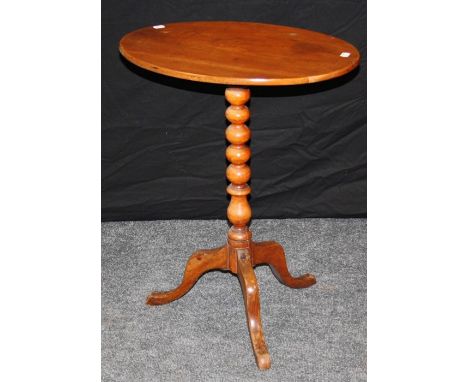 A 19th century fruitwood tripod table, the oval snap top on bobbin turned column and downswept legs. 68cm high&nbsp;