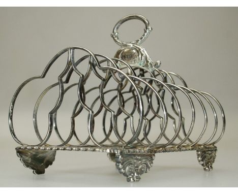 An early 19th century silver six slice toastrack, with ring handle and cloud form dividers on winged paw feet. Marks rubbed. 