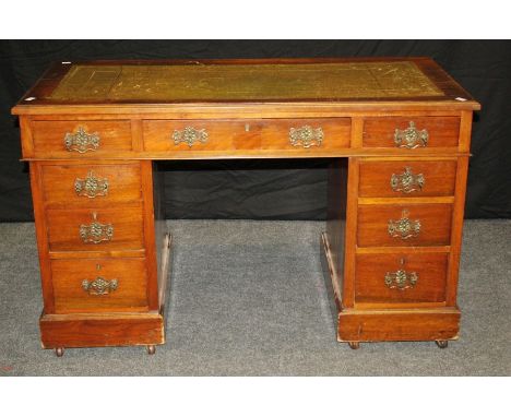 An Edwardian mahogany veneer twin pedestal writing desk, the rectangular scriber set top over three frieze drawers and three 