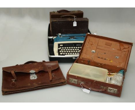 A cased Imperial Safari typewriter, a leather document case and three small hide briefcases, one containing various artist's 