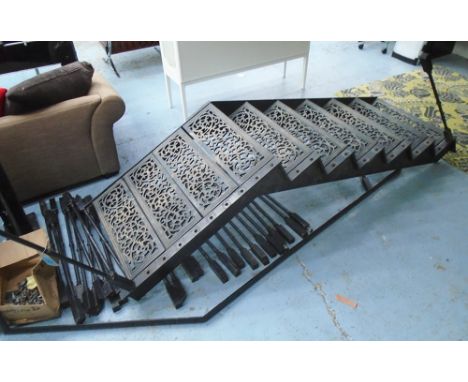 STAIRCASE, in cast iron ornately cast with seven risers at 17.5cm H (122.5cm), 127.5cm to the top of railing x 248cm L. (buye