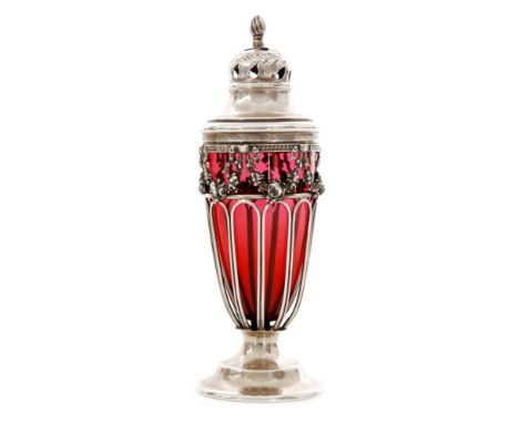 An Edwardian hallmarked silver and ruby glass sugar castor with circular foot below pierced border, floral swag frieze and do
