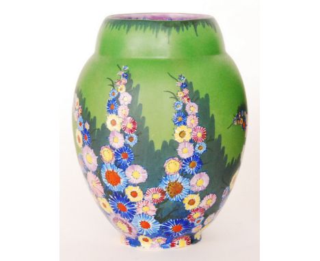 A 1930s Carlton Ware Garden pattern vase of shouldered form decorated with enamel flower heads against a green ground, printe