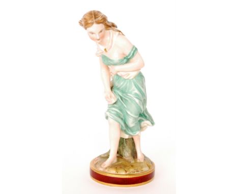 A 19th Century Royal Worcester figure by James Hadley modelled as a classical female in flowing green robes with a cream sash