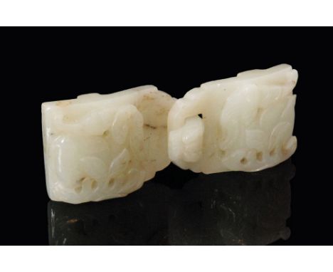 An early 19th Century Chinese pale celadon jade belt buckle in two sections, each panel relief carved with a bat above a frui