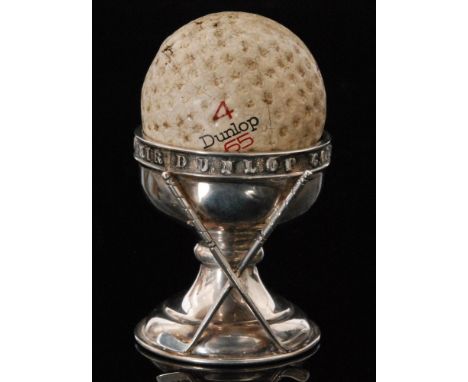 A George V hallmarked silver Dunlop 'Hole in One' souvenir golfing trophy in the form of an egg cup with applied crossed golf