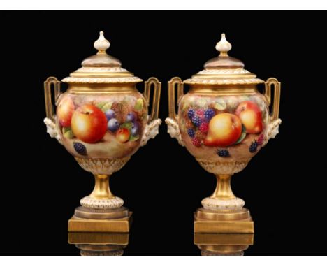 A pair of Royal Worcester Fallen Fruit shape 2363 hand painted twin handle pedestal vases, each panel decorated, the first by