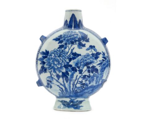 A 19th Century Chinese blue and white moon flask decorated in the Kangxi style with peonies and prunus blossom with a tessell