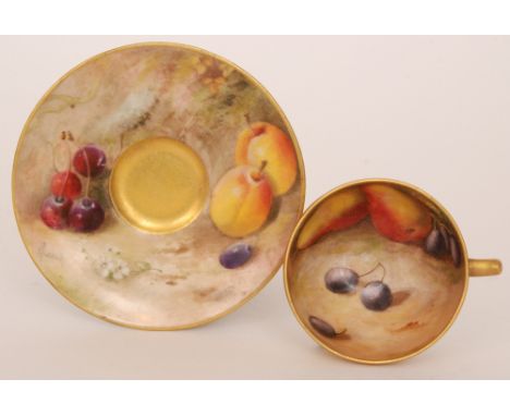 A Royal Worcester Fallen Fruits cabinet cup and saucer, the cup decorated to the interior with pears and red grapes by Harper