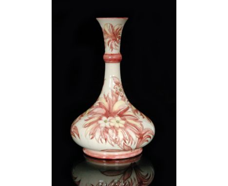 A Moorcroft vase of compressed globe and shaft form decorated in a variation of the Cornflower pattern with tubelined flowers