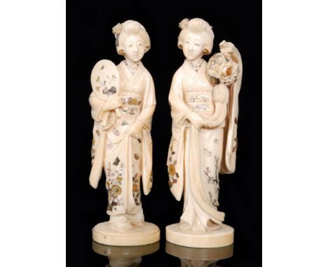 A pair of late 19th Century Japanese ivory and shibayama figures of geishas, one holding a fan with raised skirt and the othe